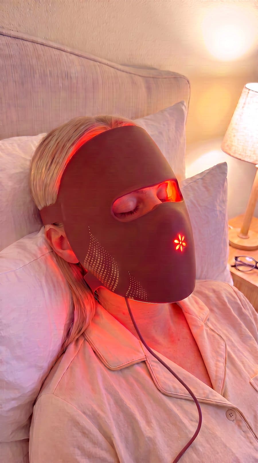 The Albelys silicone LED mask standing upright on natural linen, its cord and inline controller beside it in soft morning light